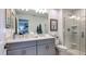 Bathroom featuring double vanity sinks, a glass-enclosed shower, and modern fixtures at 165 River Front Way, Edgewater, FL 32141