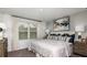 Well-lit bedroom with a large window, plush bedding, and neutral decor at 165 River Front Way, Edgewater, FL 32141