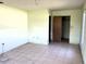 Bedroom with tile floors, light walls, window, and closet door at 2055 Avenue C, Mulberry, FL 33860