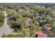 Aerial view of a home surrounded by lush trees, neighborhood, and a long driveway at 5670 Sw 34Th St, Ocala, FL 34474