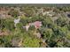 Aerial view of home with lush backyard, neighborhood, tree coverage, and long driveway at 5670 Sw 34Th St, Ocala, FL 34474