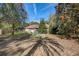 Backyard featuring green chairs, a fire pit, partial view of home and palm trees at 5670 Sw 34Th St, Ocala, FL 34474