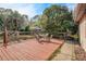 Red wood deck with outdoor dining furniture and a view of the fenced backyard at 5670 Sw 34Th St, Ocala, FL 34474