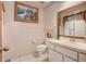 Bathroom with a large mirror, white tile and a single sink vanity at 5670 Sw 34Th St, Ocala, FL 34474