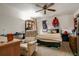 Comfortable bedroom with ceiling fan, desk area, and carpeted floor at 5670 Sw 34Th St, Ocala, FL 34474