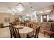 Bright dining room with hardwood floors, a brick wall, a decorative chandelier, and plenty of space for entertaining at 5670 Sw 34Th St, Ocala, FL 34474
