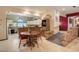 Eat-in kitchen with open access to the dining room, white cabinets, tile floor, and natural light at 5670 Sw 34Th St, Ocala, FL 34474