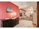 Foyer with red wall, antique cabinet, and tile flooring at 5670 Sw 34Th St, Ocala, FL 34474