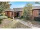 Charming brick home featuring a covered front porch and lush landscaping at 5670 Sw 34Th St, Ocala, FL 34474