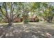 Brick home featuring mature trees and a large front yard at 5670 Sw 34Th St, Ocala, FL 34474