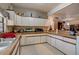 A kitchen with white cabinets, a stainless steel sink, appliances, and tile flooring at 5670 Sw 34Th St, Ocala, FL 34474