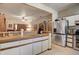 Bright kitchen with white cabinets and stainless-steel appliances, opening up to the living and dining areas at 5670 Sw 34Th St, Ocala, FL 34474