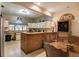 Spacious kitchen featuring white cabinets, tile flooring, a window above the sink, and an island with a breakfast bar at 5670 Sw 34Th St, Ocala, FL 34474