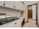Bright laundry room with modern machines and an adjacent storage area at 5670 Sw 34Th St, Ocala, FL 34474