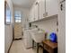 Laundry room with washer, dryer, utility sink, and storage cabinets at 5670 Sw 34Th St, Ocala, FL 34474