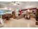 Open living area with a brick accent wall, tiled floors, and connection to the kitchen at 5670 Sw 34Th St, Ocala, FL 34474