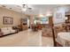 Open-concept living area with tile flooring, a brick accent wall, and a view into the kitchen at 5670 Sw 34Th St, Ocala, FL 34474