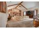Cozy living room with vaulted ceilings, a brick fireplace, and comfortable furnishings at 5670 Sw 34Th St, Ocala, FL 34474