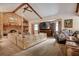 Living room features vaulted ceilings, exposed beams, a brick fireplace, and ample natural light at 5670 Sw 34Th St, Ocala, FL 34474