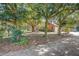 Landscaped yard featuring mature trees surrounding a brick home at 5670 Sw 34Th St, Ocala, FL 34474