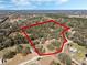 An aerial view of a treed homesite with a red property outline at 12308 Se 112Th Avenue Rd, Belleview, FL 34420