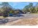 Large metal awning, with multiple cars, trucks, and an RV on a sunny day at 12308 Se 112Th Avenue Rd, Belleview, FL 34420