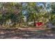 Multiple sheds in the backyard surrounded by a canopy of mature trees at 12308 Se 112Th Avenue Rd, Belleview, FL 34420