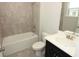 Bathroom with a shower and bathtub, with gray tile and a white vanity at 5196 Goldfinch St, St Cloud, FL 34771