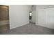 Bedroom with gray carpeting, white trim, and a connecting bathroom at 5196 Goldfinch St, St Cloud, FL 34771