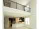 Living room with high ceilings, a view of the upstairs loft and an open-concept kitchen at 5196 Goldfinch St, St Cloud, FL 34771