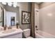Well-lit bathroom with a shower-tub combo, neutral colors, and decorative shower curtain at 16198 Honey Harvest St, Winter Garden, FL 34787