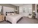 Beautiful bedroom featuring a large comfortable bed, plush carpeting, and lots of natural light from the windows at 16198 Honey Harvest St, Winter Garden, FL 34787