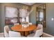 Elegant dining room features a round table, six upholstered chairs, and decorative wall art at 16198 Honey Harvest St, Winter Garden, FL 34787