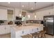 Bright kitchen with stainless steel appliances, large island, pendant lighting, and white cabinets at 16198 Honey Harvest St, Winter Garden, FL 34787