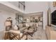 Open-concept living room featuring high ceilings, view of kitchen, and natural light at 16198 Honey Harvest St, Winter Garden, FL 34787