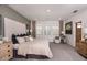 Spacious main bedroom with large headboard, neutral colors, and ample natural light at 16198 Honey Harvest St, Winter Garden, FL 34787
