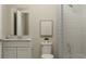 Bright bathroom with a modern vanity, framed art, and a shower featuring a patterned curtain at 2615 Skyline Loop, Kissimmee, FL 34758