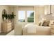 Inviting bedroom with a comfortable bed, seating area, neutral tones, and natural light at 2615 Skyline Loop, Kissimmee, FL 34758