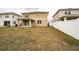Large backyard with a patio and white vinyl fence, great for outdoor activities at 348 Lake Smart Cir, Winter Haven, FL 33881