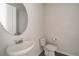Clean powder room with white fixtures, modern faucet, and an oval mirror above the sink at 348 Lake Smart Cir, Winter Haven, FL 33881