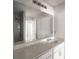 Bathroom with a large mirror, single sink, and a shower/tub combo in the background at 348 Lake Smart Cir, Winter Haven, FL 33881