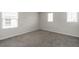 Neutral carpeting and large windows provide lots of light that offer a comfortable flooring solution at 348 Lake Smart Cir, Winter Haven, FL 33881