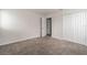 Bright bedroom featuring neutral carpet, a closet, and a door to a bathroom at 348 Lake Smart Cir, Winter Haven, FL 33881