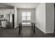 Dining area next to kitchen with stainless steel refrigerator, and a black dining table at 348 Lake Smart Cir, Winter Haven, FL 33881
