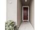 Inviting front entrance with a classic six-panel door and neutral facade at 348 Lake Smart Cir, Winter Haven, FL 33881
