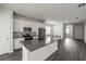 Modern kitchen featuring white cabinets, stainless steel appliances, a gray countertop, and wood-look flooring at 348 Lake Smart Cir, Winter Haven, FL 33881