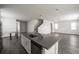 Open-concept kitchen boasts a large island, stainless steel appliances, and sleek white cabinetry at 348 Lake Smart Cir, Winter Haven, FL 33881