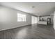 Bright living room showcasing wood-look floors and white walls at 348 Lake Smart Cir, Winter Haven, FL 33881