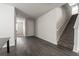 Living room with a staircase and doorway, featuring neutral walls and gray flooring at 348 Lake Smart Cir, Winter Haven, FL 33881