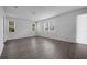 Well-lit living room featuring hardwood floors and multiple windows for ample natural light at 348 Lake Smart Cir, Winter Haven, FL 33881